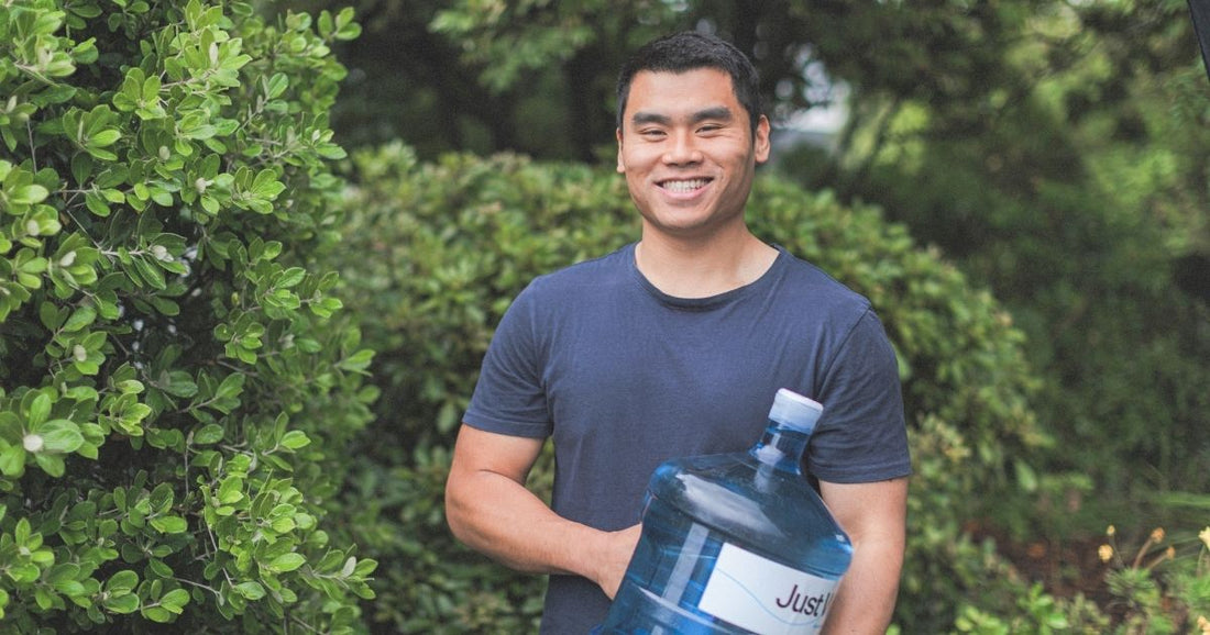 Man holding a bottle of Just Water 