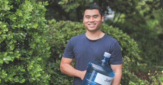 Man holding a bottle of Just Water 