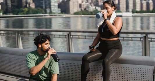couple drinking water after a workout