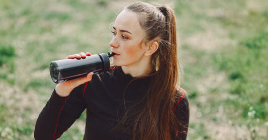 Woman drinking filtered water from a water bottle