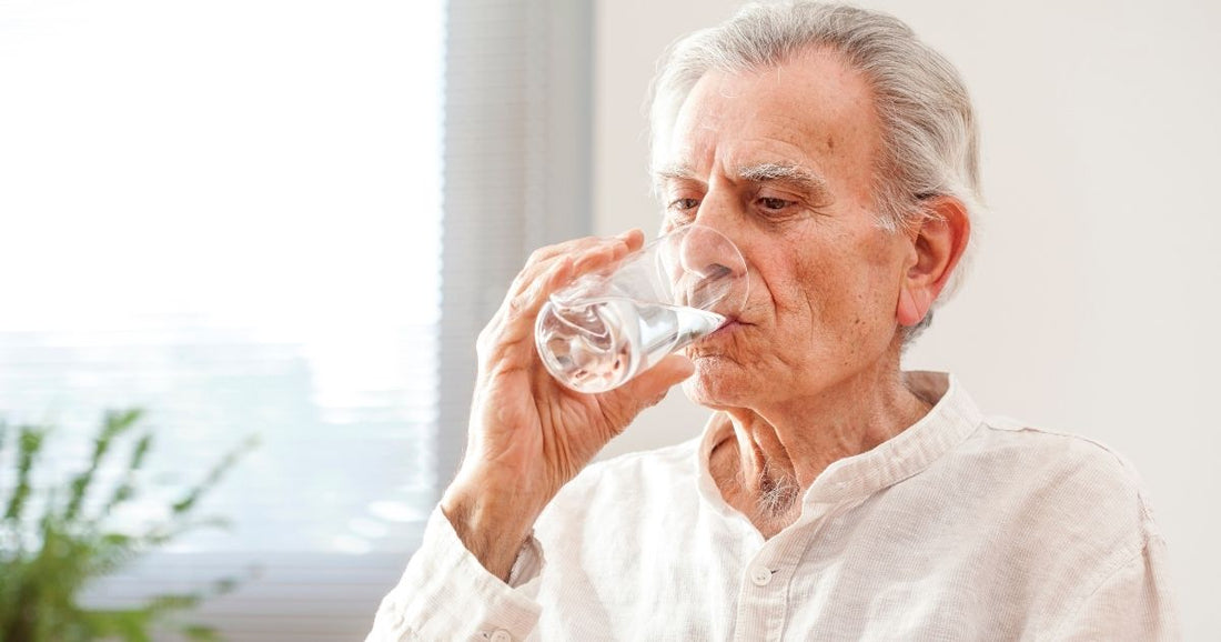 Elder man drinking water to stay hydrated