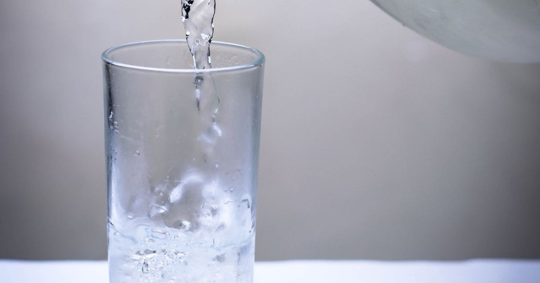 Pouring refreshing filtered water into cup